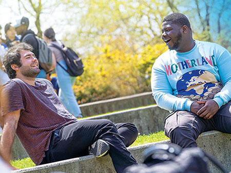 Two students sitting together on the Staller steps.