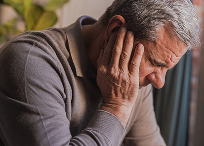 Man holding his neck